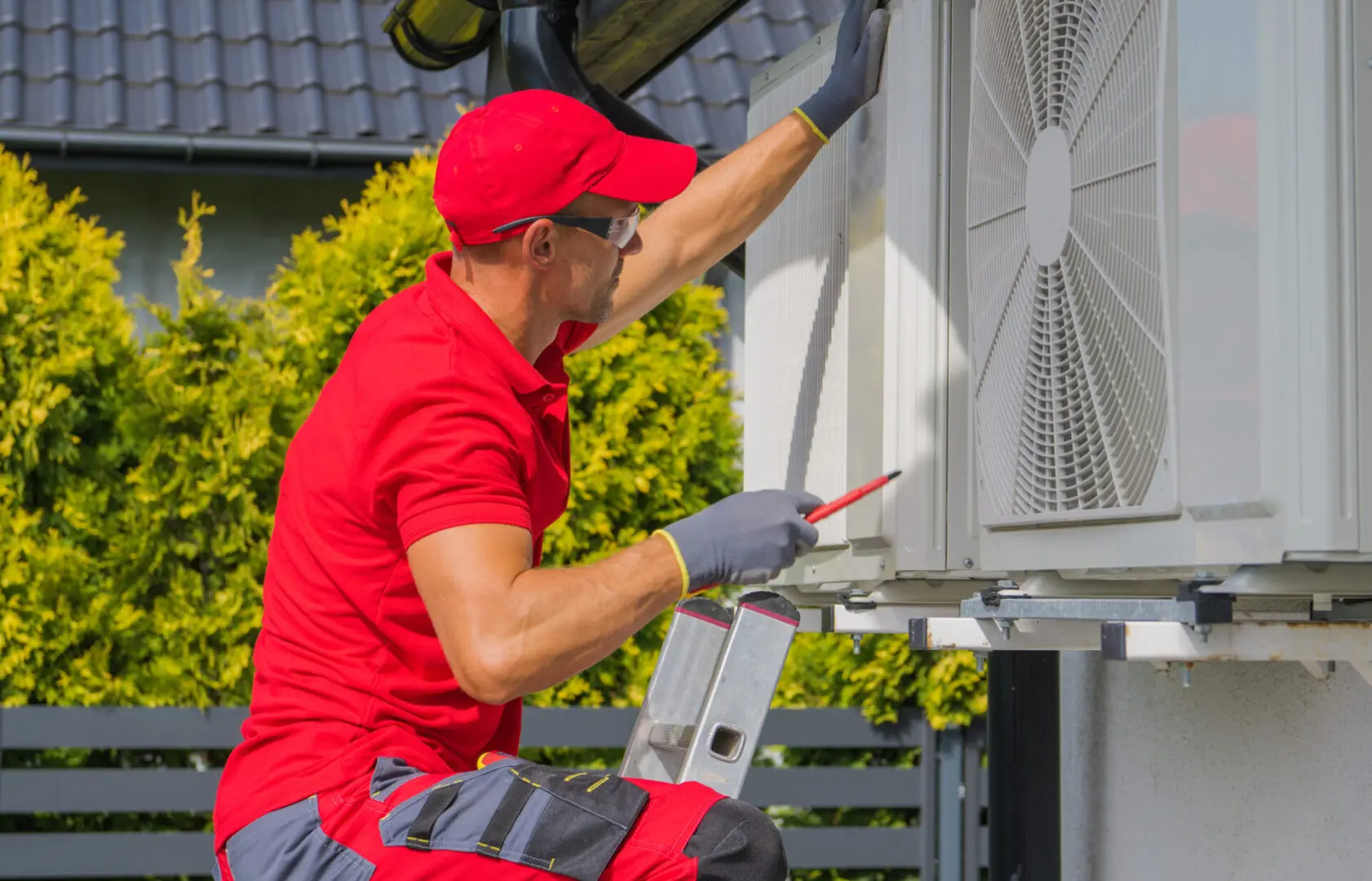 Professional AC Technician Performing Regular Maintenance Check of Residential Air Conditioning External Unit.